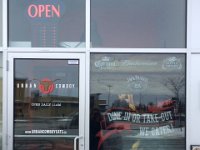 Store front graphics  Cut vinyl applied on exterior glass gives a sharp look for the front door.  The printed non-blockout vinyl applied on the interior face of the glass adds to the smoky look to the graphic as glass has a slight tint.